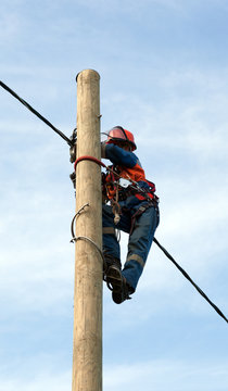 electrician installs insulated wire for electric main