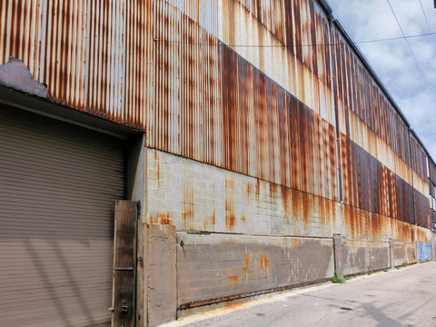 Long rusty sheet metal warehouse wall - landscape color photo
