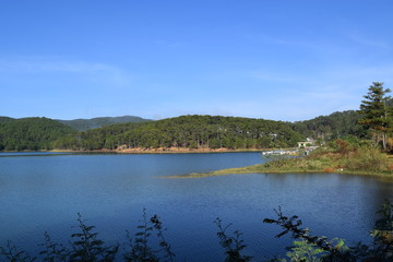 Fototapeta na wymiar Tuyen Lam lake with pine forest on the hill in Dalat, Vietnam