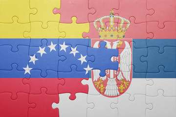 puzzle with the national flag of venezuela and serbia . concept