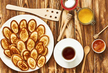 Pancakes or fritters on wooden background