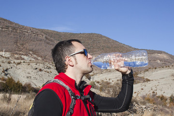 thirsty mountaineer drinking water