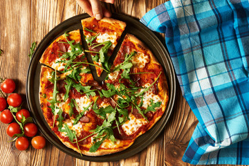 Home made pizza on wooden table