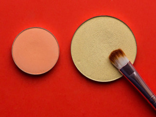 For Make-up. Bright shade with  brush on a red background 