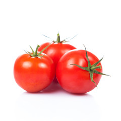 fresh tomatoes with green leaves isolated on white background