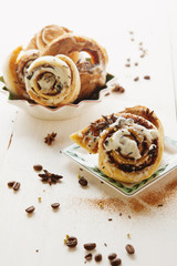 Cinnabons with raisins, cinnamon and vanilla sauce