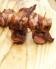Deep fried sausages rolled in bacon