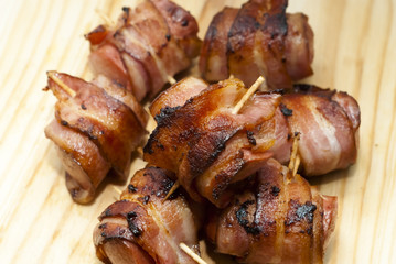 Deep fried sausages rolled in bacon