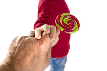 man hand give candy to child