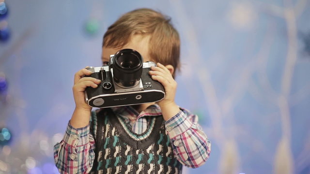 Little boy with old camera