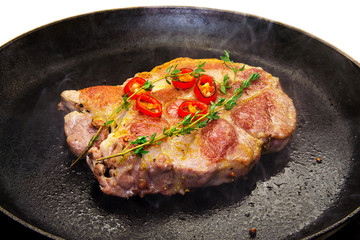 Cooking a steak in a frying pan
