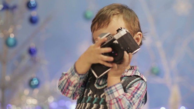 Little boy with old camera