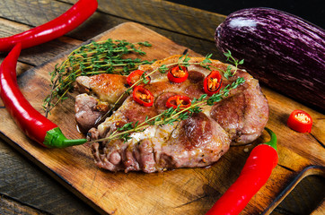 Cooking steak with thyme and chilli.