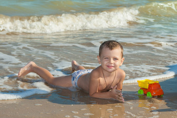 Happy  little boy having fun on the beach