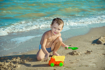 Happy  little boy having fun on the beach