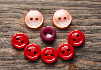 Smiling face made of colored buttons close-up