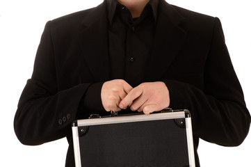 man keeps in a black jacket and a black shirt before himself a metal case