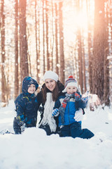 Winter portrait of mother and two sons
