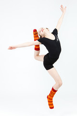 Teenager girl doing gymnastics dance in jumping on  white