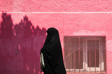 Turkish woman in traditional Islamic clothing Chador walking  the street in Istanbul .Turkey .