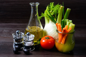 Olive oil with pepper mill tomato and vegetables