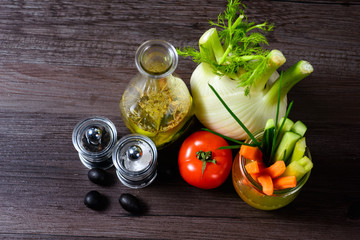 Olive oil with pepper mill tomato and vegetables