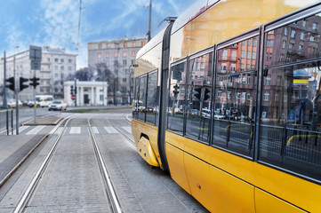 Close up of a modern yellow tram in the rails