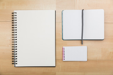 Three notepad types on wood