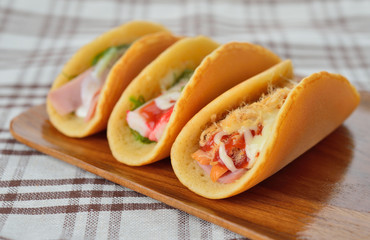  rolled pancakes stuffed ham and cheese.