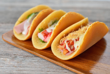  rolled pancakes stuffed ham and cheese.