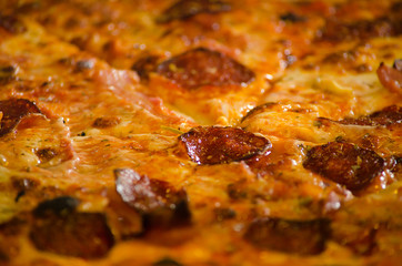 Tasty pizza with sausage and melted cheese