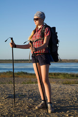 Young girl tourist with nordic walking