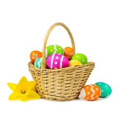 Easter basket with colorful eggs and daffodils on a white background