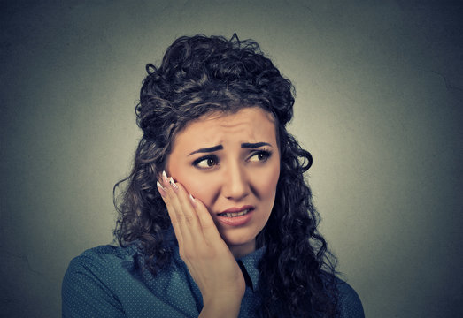 young woman with sensitive toothache crown problem about to cry from pain