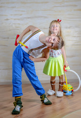 Cute playful little boy and girl cleaning house