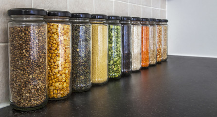 Health food, seeds & pulses, focus on nearest jar, fading.