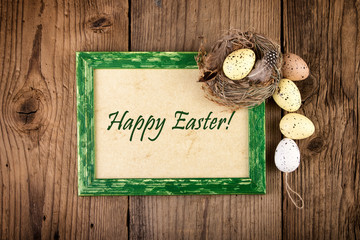 Easter decoration with green wooden frame. Top view Text Happy Easter.