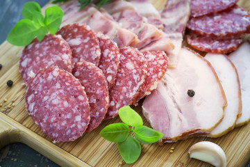 Slices of salami and bacon, selective focus