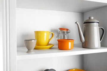 Tableware on shelf in the kitchen cupboard