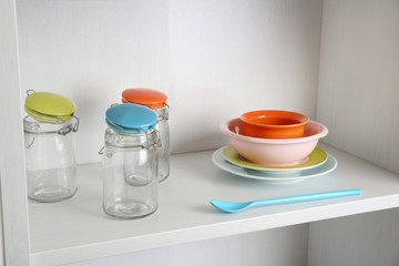 Tableware on shelf in the kitchen cupboard