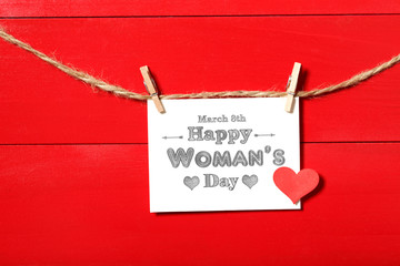 Womans day message card hanging with clothespins