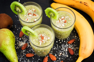nutritious smoothie with oat bran and almonds on a black backgro