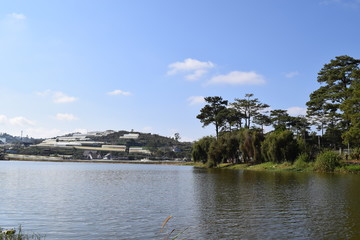 Than Tho lake with pine forest on the bank in Dalat, Vietnam