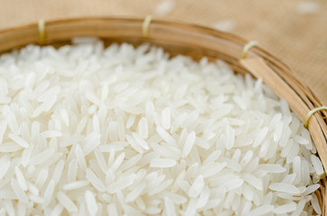 Raw white rice in weave basket.