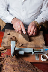 old man Torcedor rolling hand made cigars parejos using traditional technology
