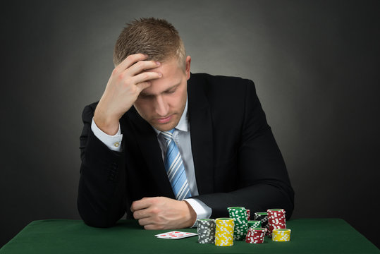 Portrait Of A Depressed Young Male Poker Player