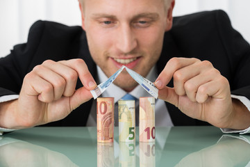 Businessman Making House Of Banknotes