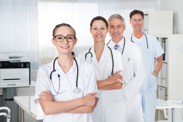 Confident Medical Staff Standing With Doctor