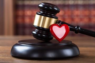 Mallet And Heart On Table In Courtroom
