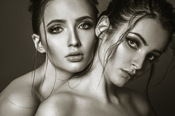 Fototapeta premium Two young attractive womans closeup face portrait. Fashion style